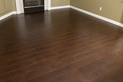 Beautiful Newly Installed Brown Laminate Flooring and Baseboards in Home.